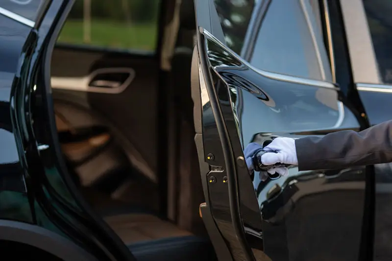 Chauffeur opening car door Chauffeur opening car door