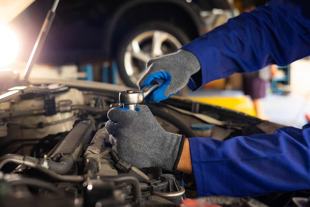 mechanic repairs car in garage