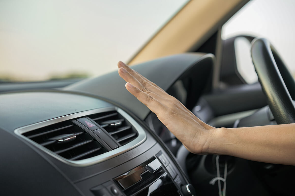 woman's hand is checking the air flow